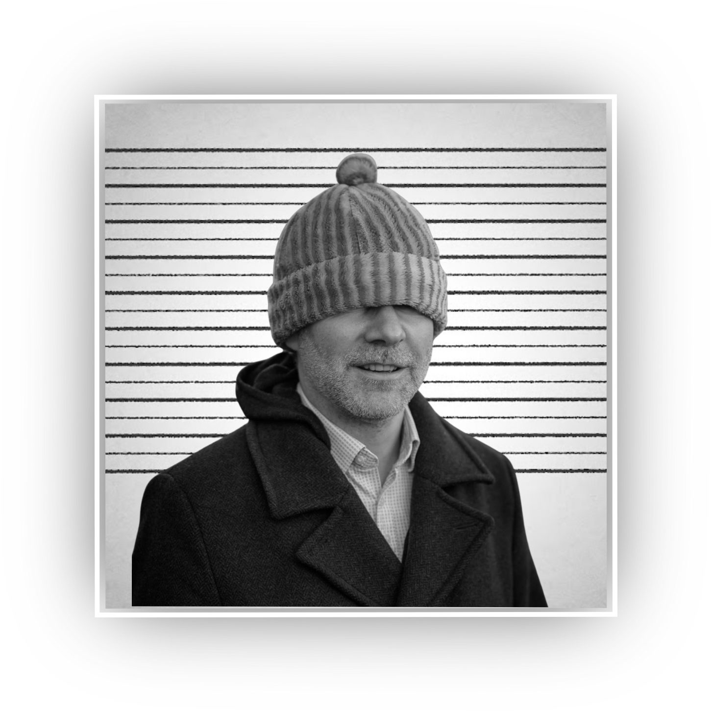 A black and white mug shot of a clown in a silly hat, trying to break everything.